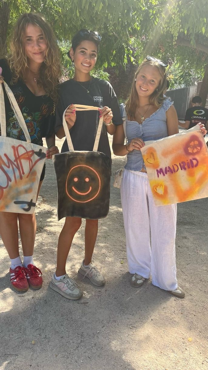 Students pose with tote bags they made in Madrid on a weekend trip.