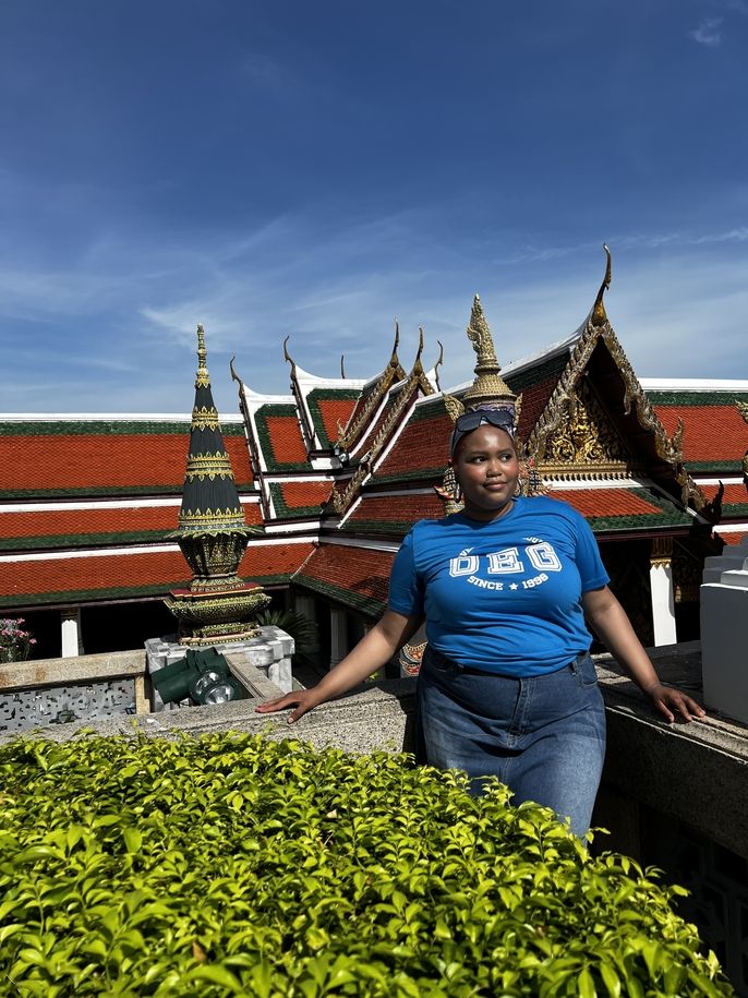 Ciani stands overlooking the grand palace in thailand. it is her first week since moving to thailand from the us