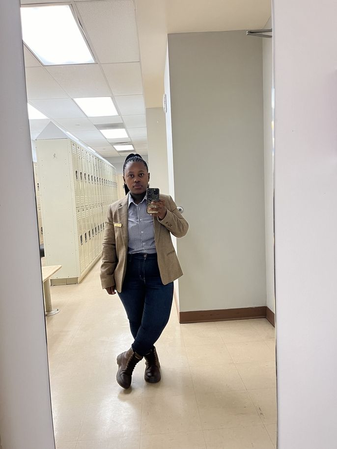 Zandile takes a selfie in a mirror at work.