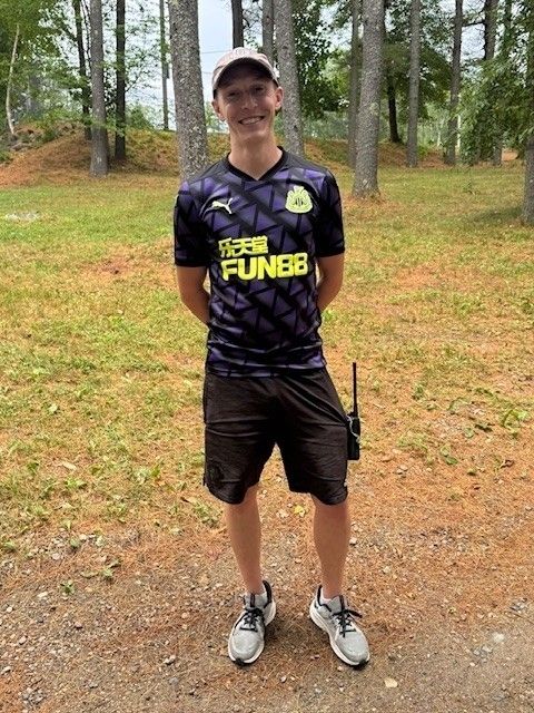 Peter Brimstone stands in the woods of Pierce Camp Birchmont in New Hampshire.