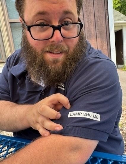 Camp Sno-Mo director Chris Ellis shows off the camp logo on his shirt.
