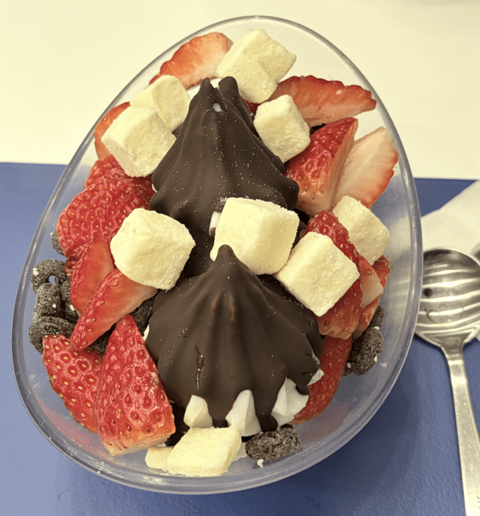 Frozen Yogurt with strawberries, chocolate, and cheese cubes.