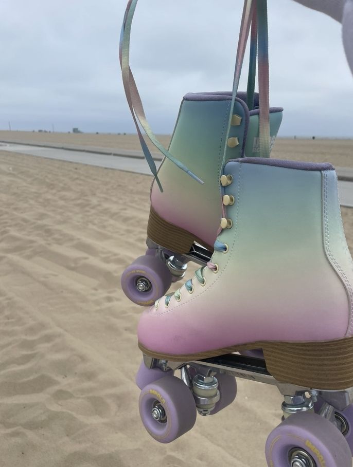 rainbow rollerskates in front of beach view