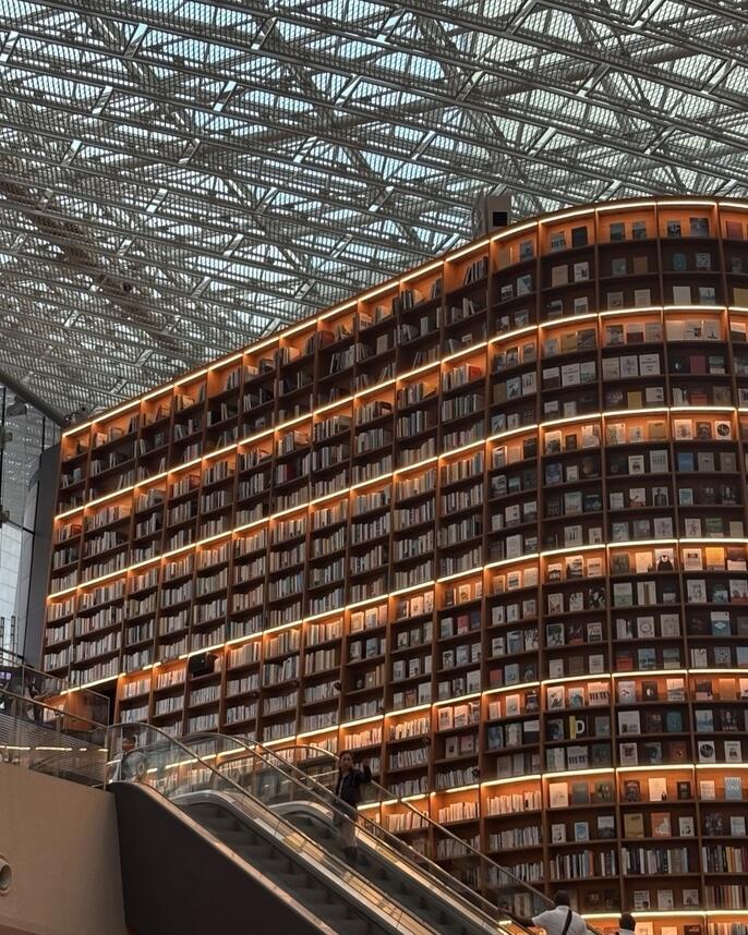 Close up of tall bookshelf (two stories, floor to roof)