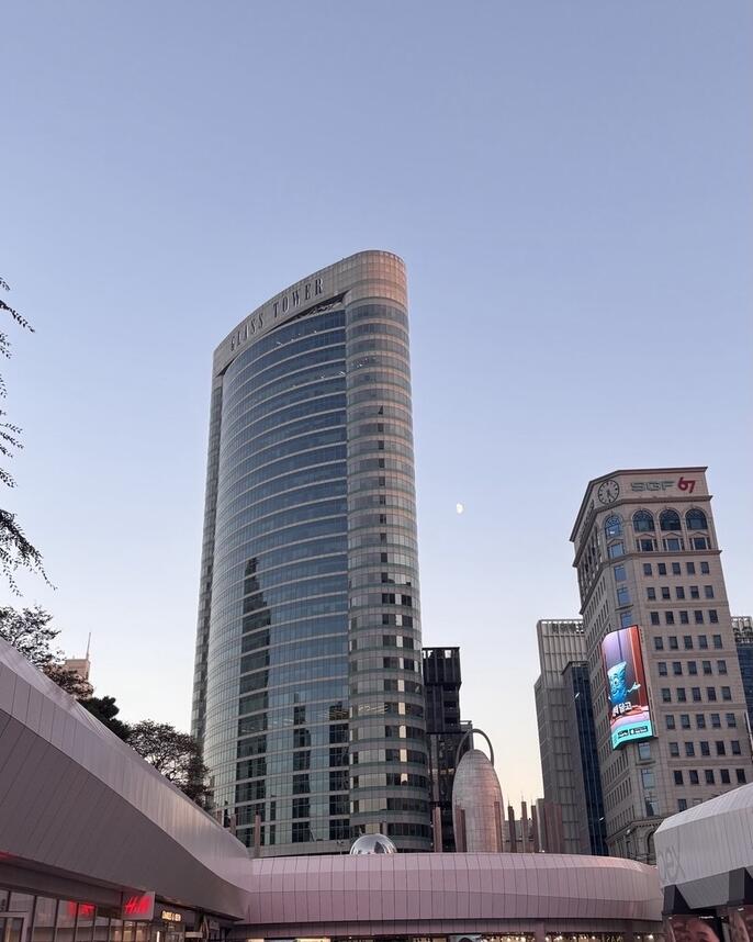 city street to sky view of tall city buildings