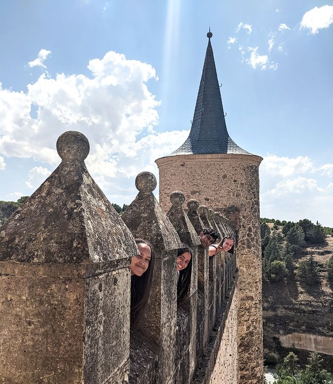 High school students posing in the turrets of a castle in Madrid