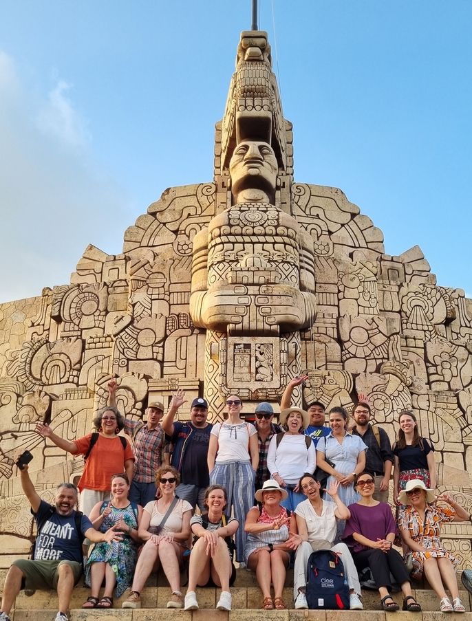Educators pose at monument in Merida