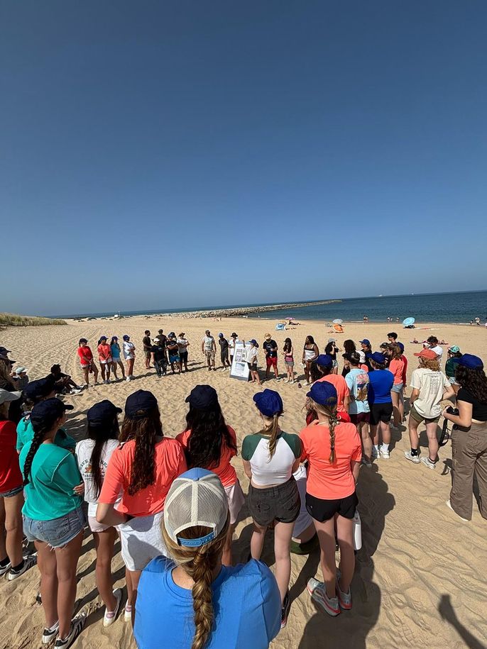 High school participants group photo on beach