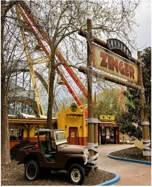 an amusement park gate decorated to resemble a safari gate