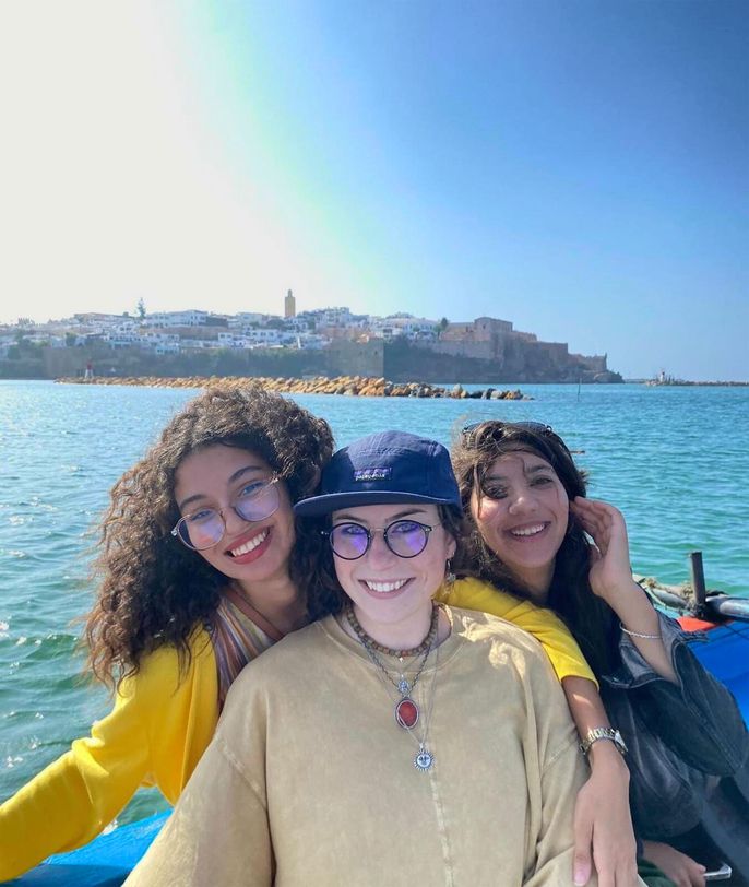 rabat-three-girls-boat-coastline-background