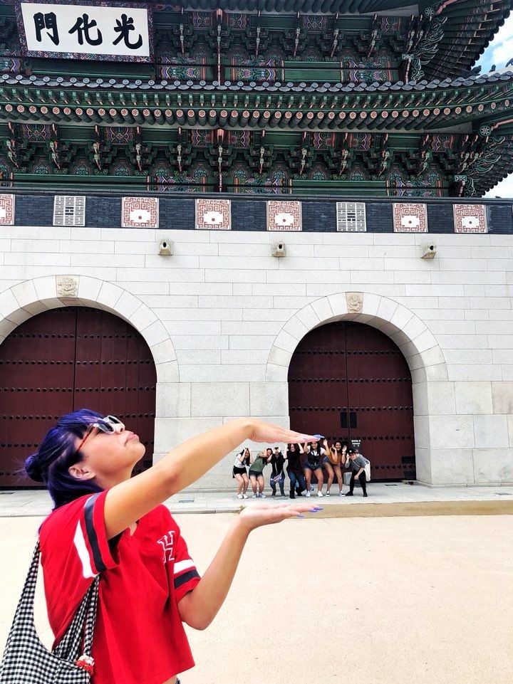 Students posing in front of Gwanghamun Palace in Seoul, South Korea.
