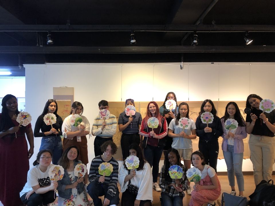 Students posing with their self-made fans of Korean folk paintings in the Gahoe Museum.