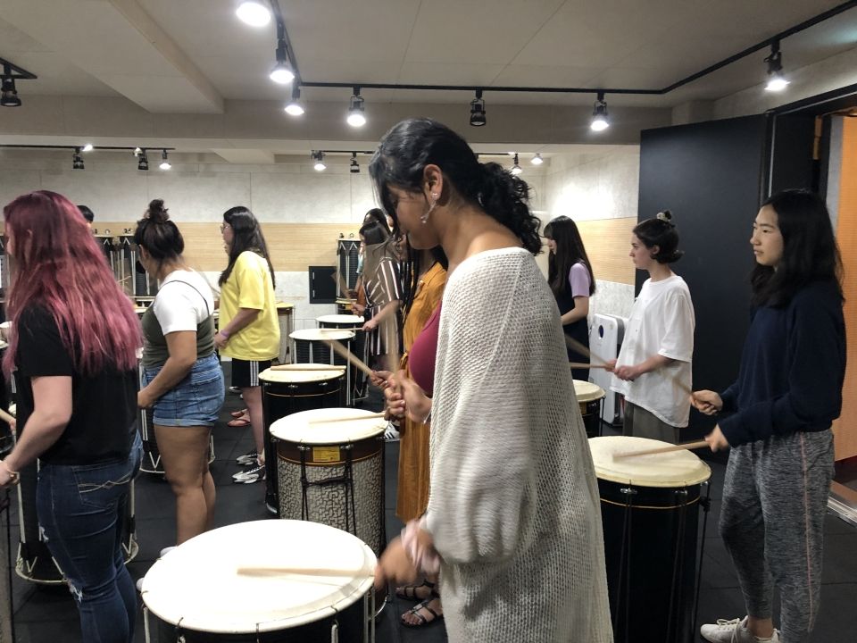 Students learning how to play Korean traditional drums.