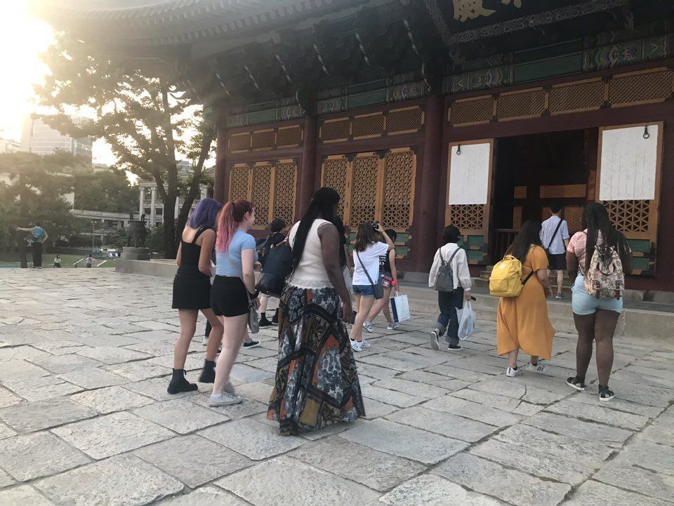 Students and leaders standing in front of Deoksugung Palace