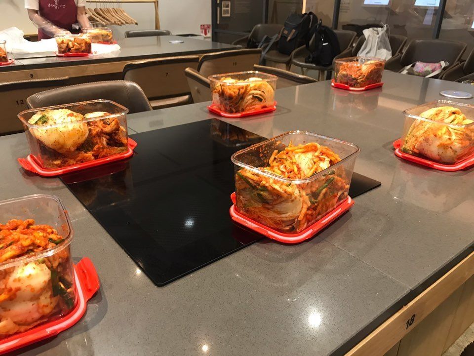 Jars of Kimchi sitting on a table