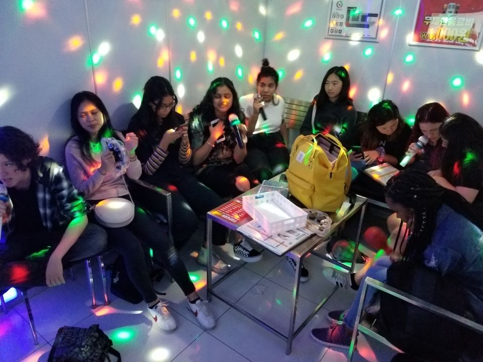 Students singing songs in a Karaoke room.