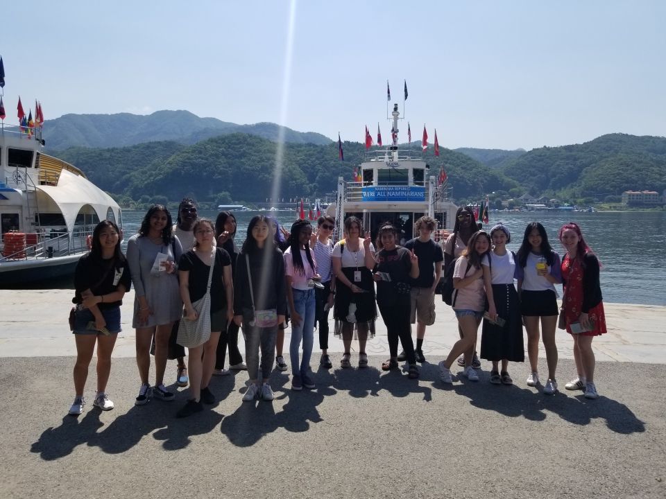 Students standing in front of the ferry that will take them to Nami Island.