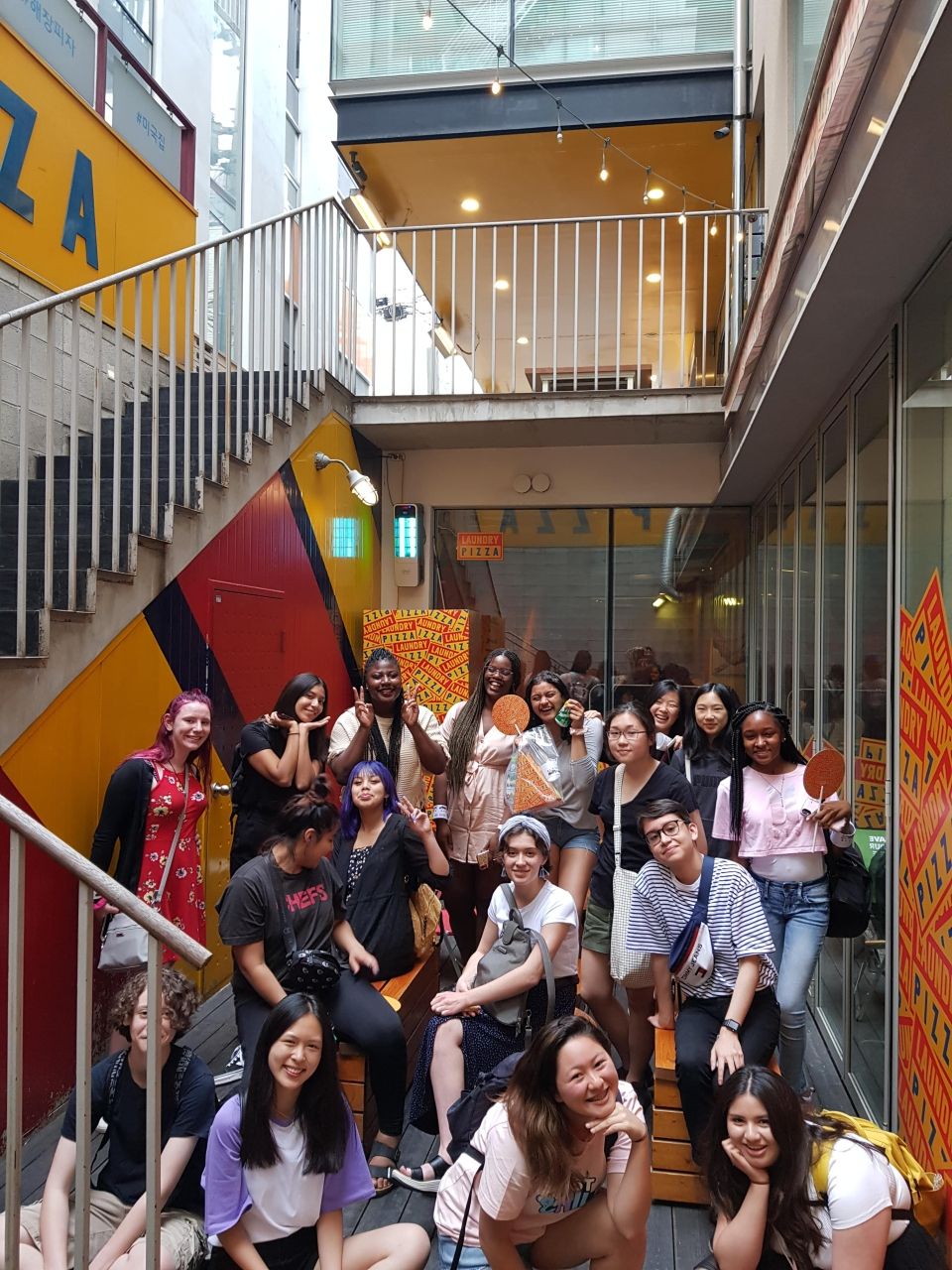 Group photo with students and leaders in front of the restaurant Laundry Pizza.