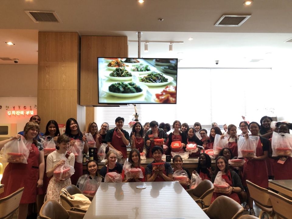 Group picture of students holding their finished containers of Kimchi.