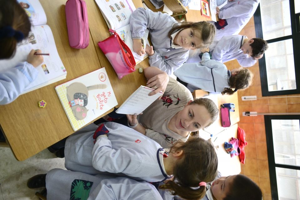 Teach in Spain teacher with students in classroom