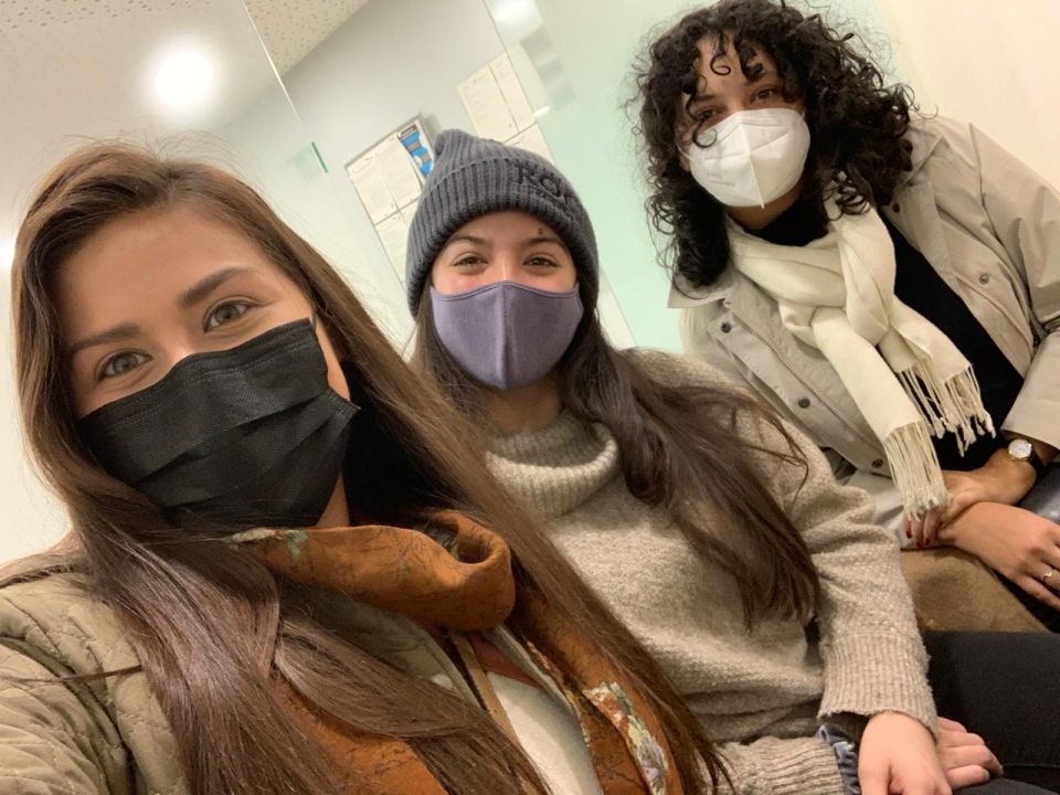 A group of women wearing clothing and masks