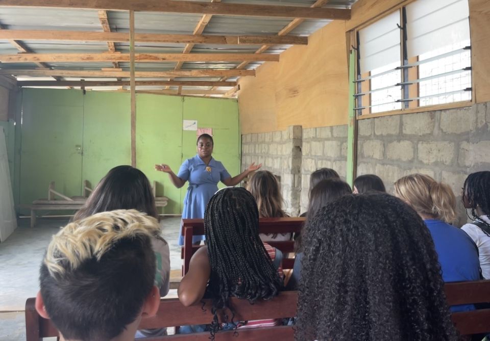 Madam Mabel, headmistress of Future Leaders UCC, sharing the history of the school with the Global Navigators. 