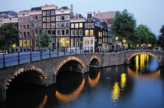 amsterdam canal with lights at night
