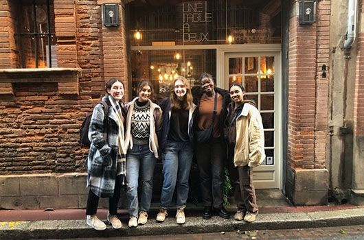 study abroad girls outside of french restaurant