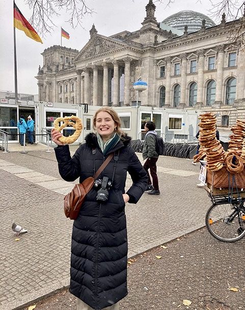 Reichstag bulding in germany student eating pretzel