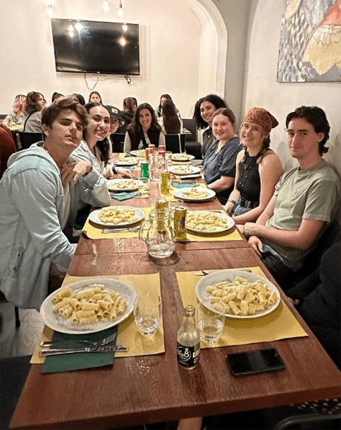 study abroad students eating a meal in italy
