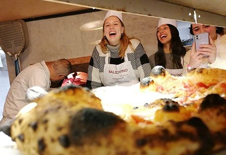 study abroad students in rome cooking pizza