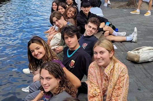 amsterdam study abroad students sitting by canal