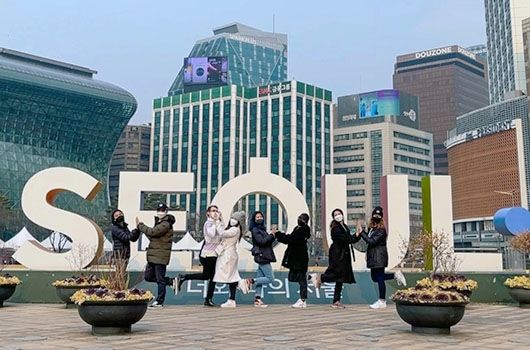 seoul city sign with students posing
