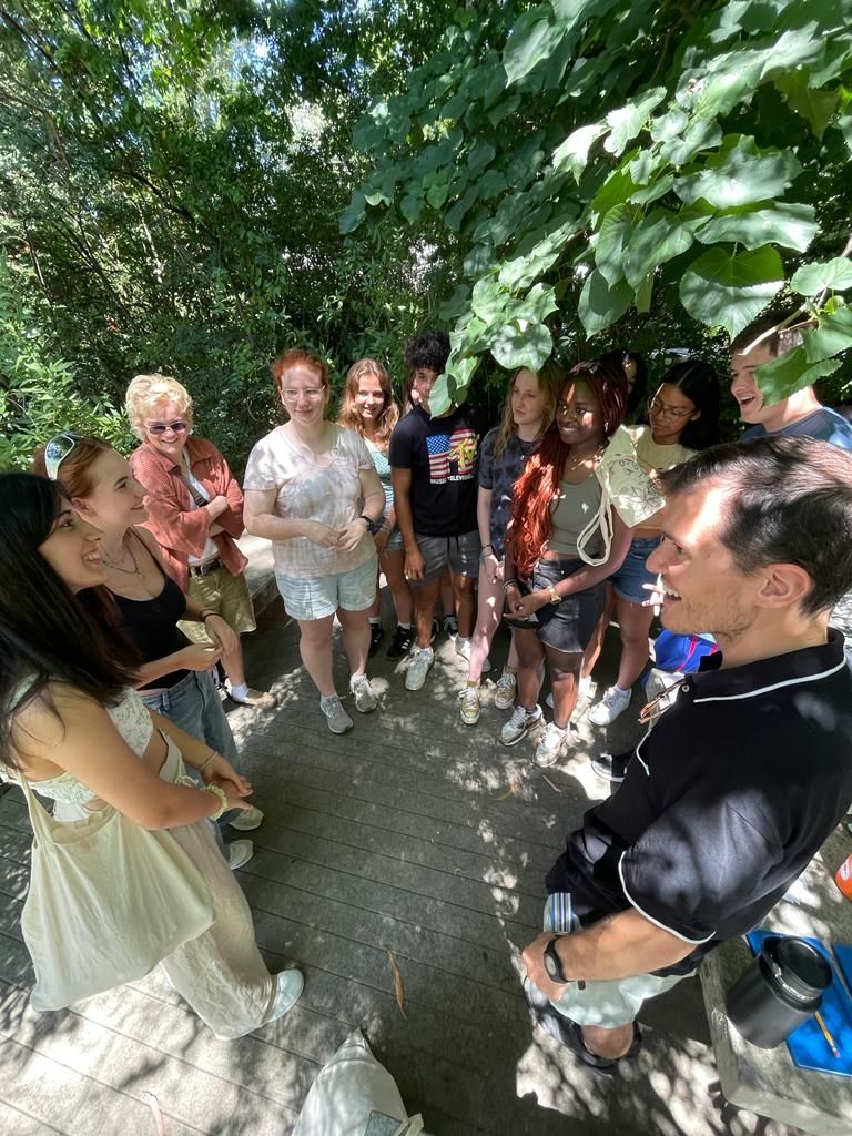 Language instructor Rodrigo engaging with language students in the park. Smiles all around!