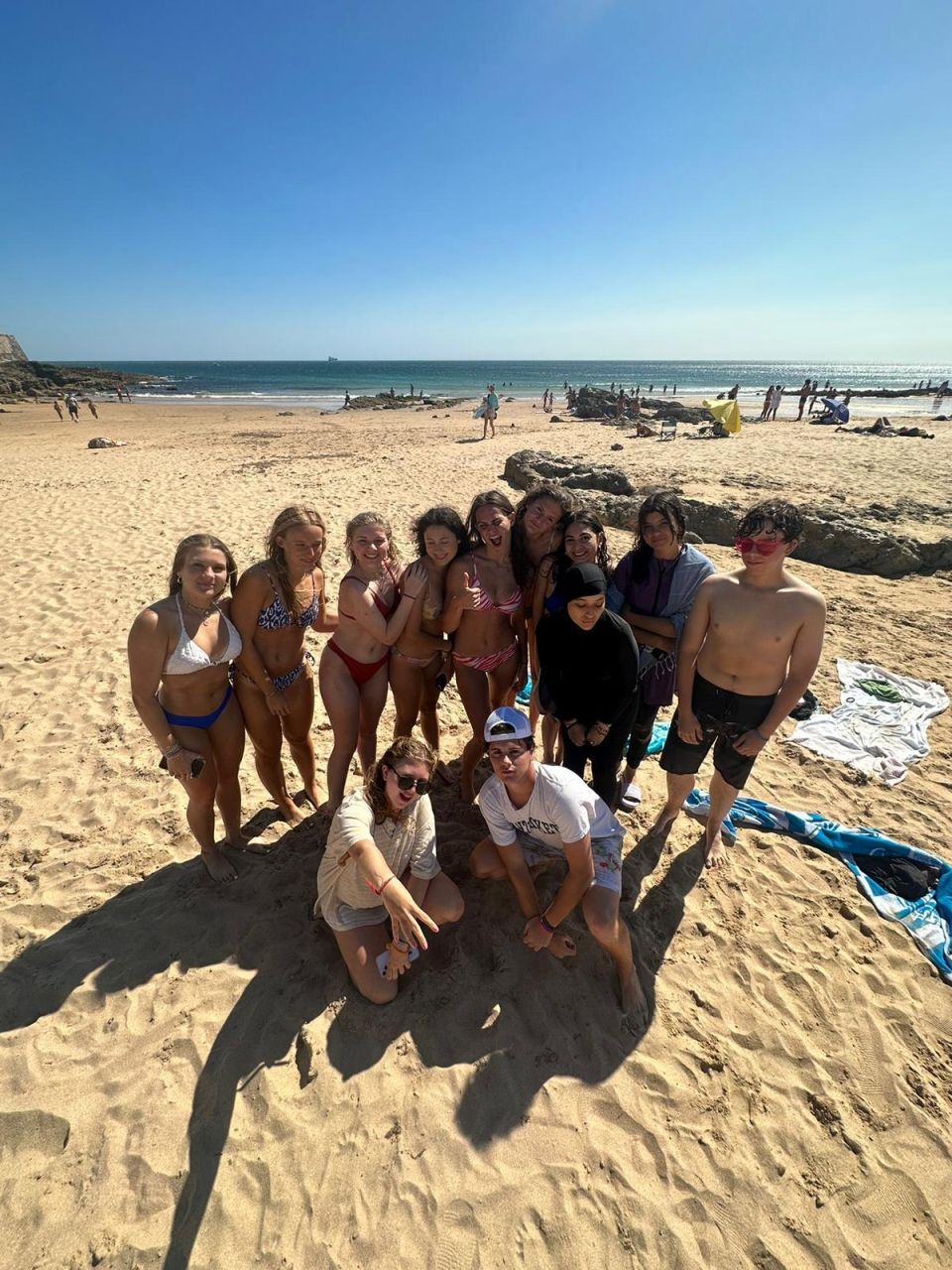 Group at students at the beach - looking happy in the sun!