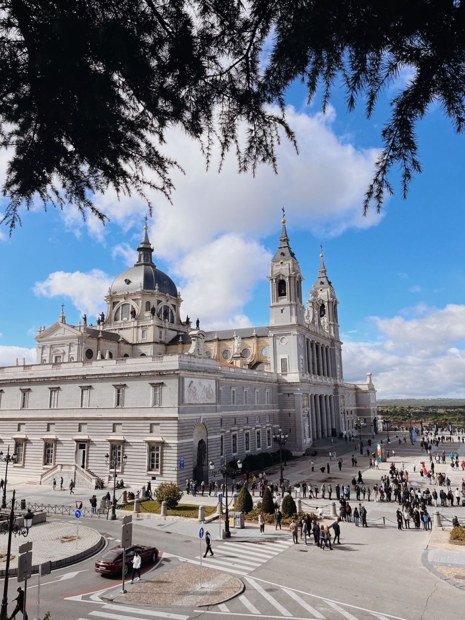 View of Almudena Cathedral in Madrid, Spain taken from up high with many visitors walking around