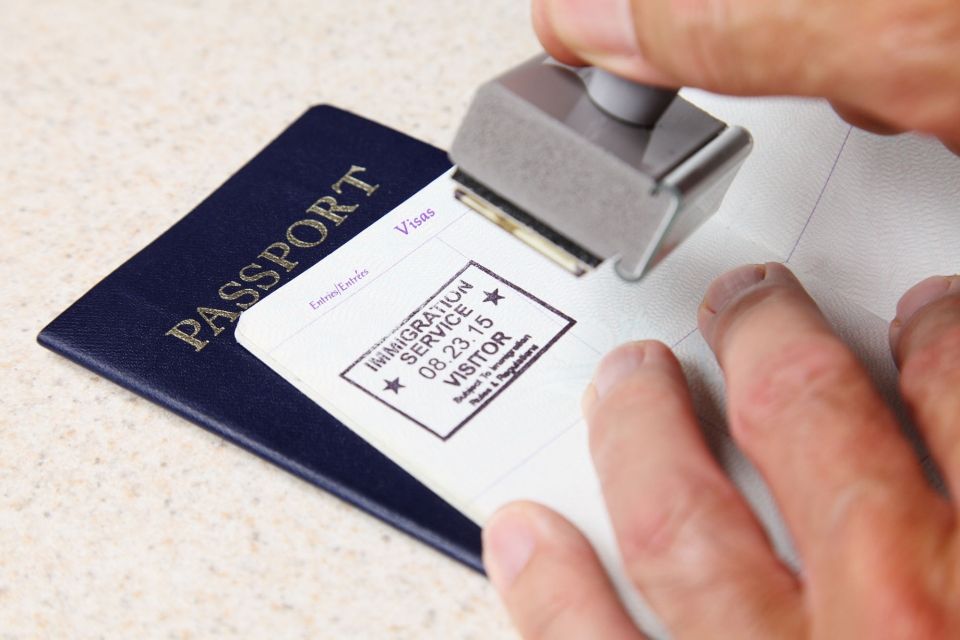 Hands stamping a passport book