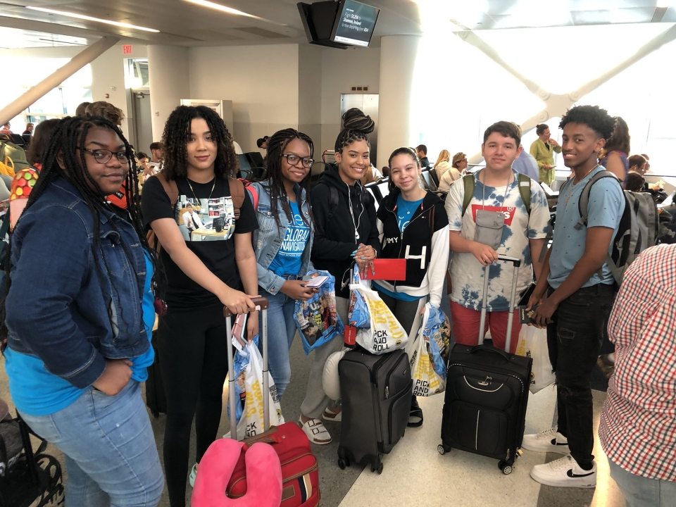 High school students with their luggage in Rome airport waiting for flight