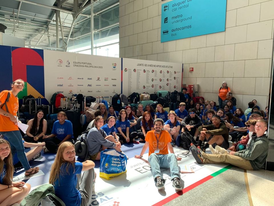 Students and staff huddled at Lisbon airport on arrival day