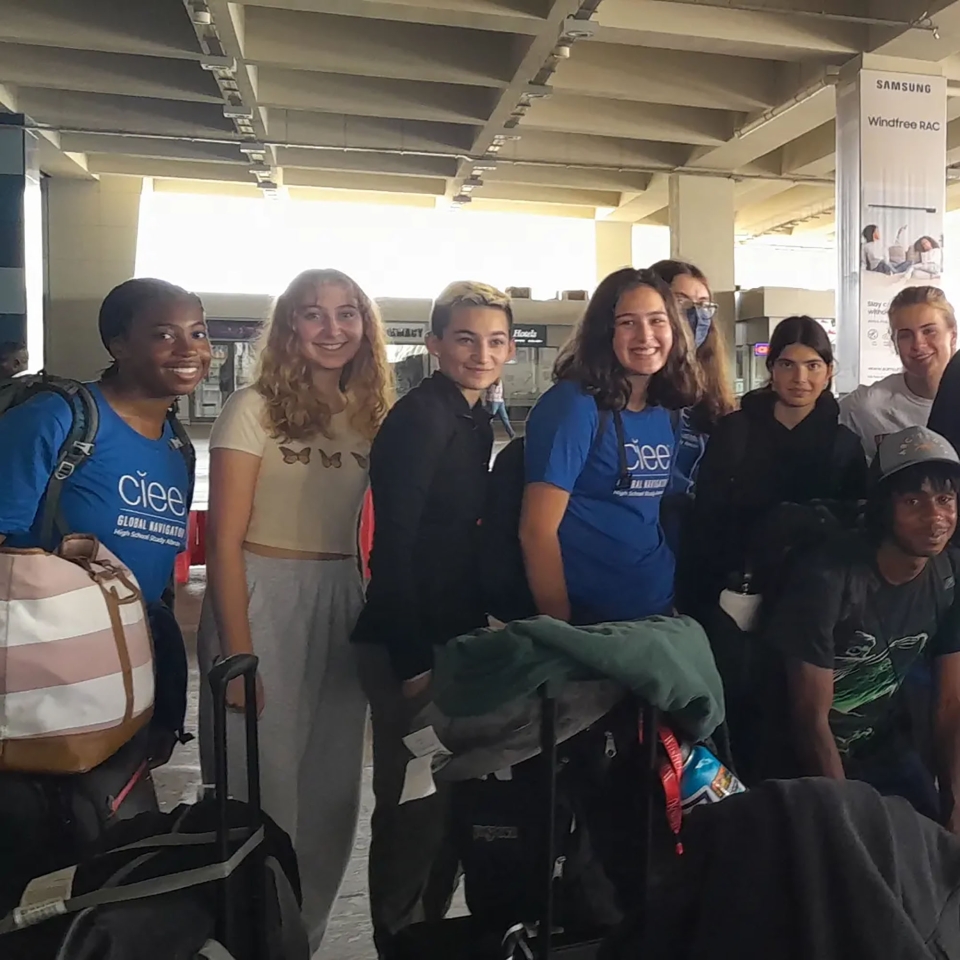 Students posing in a group at the airport