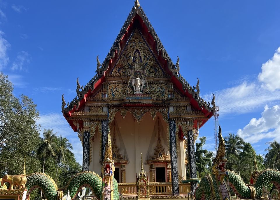 A colorful temple with naga flanking the staircase.