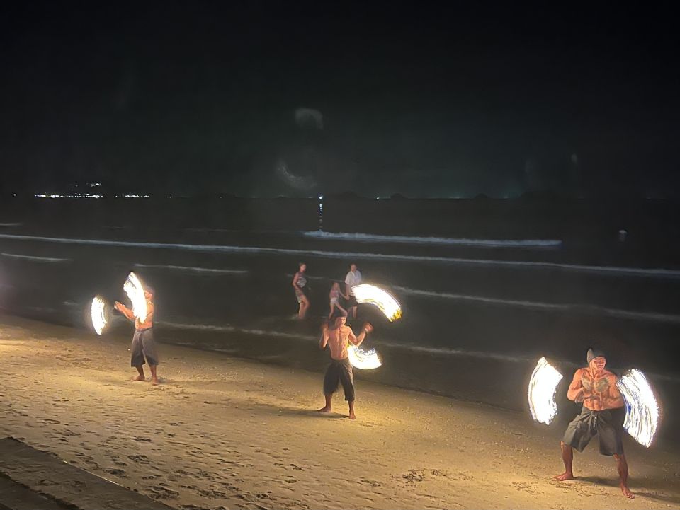Three Fire performers twirling flaming torches.