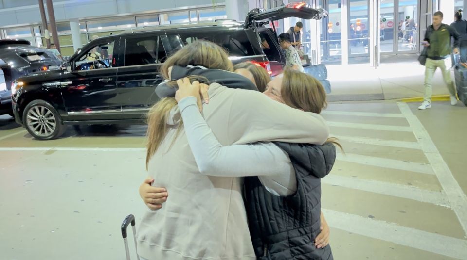 High school student hugging host family on departure day