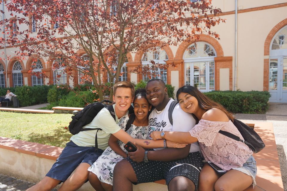 high school summer abroad cohort in Toulouse hugging