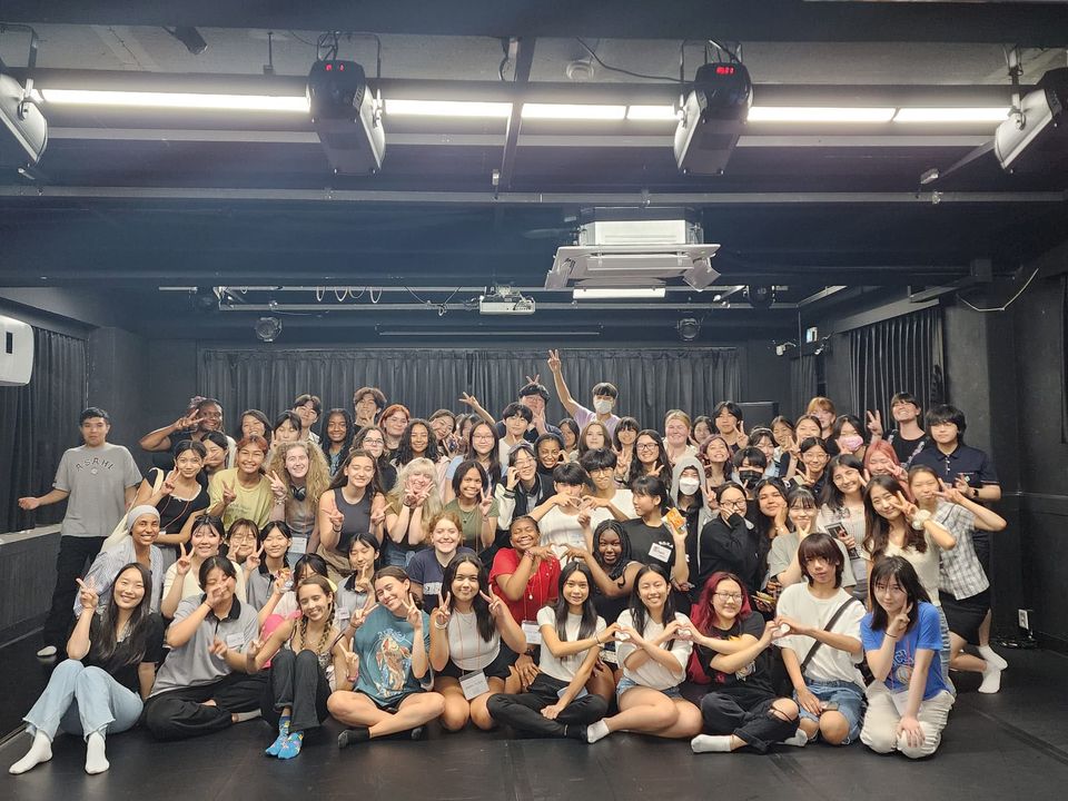 Group photo of high school participants in Seoul smiling at a South Korean school 