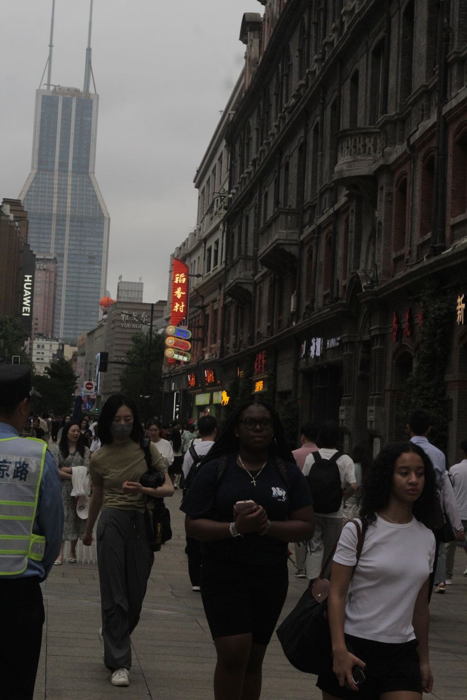 Two students and a CIEE staff cross an intersection during the scavenger hunt. 