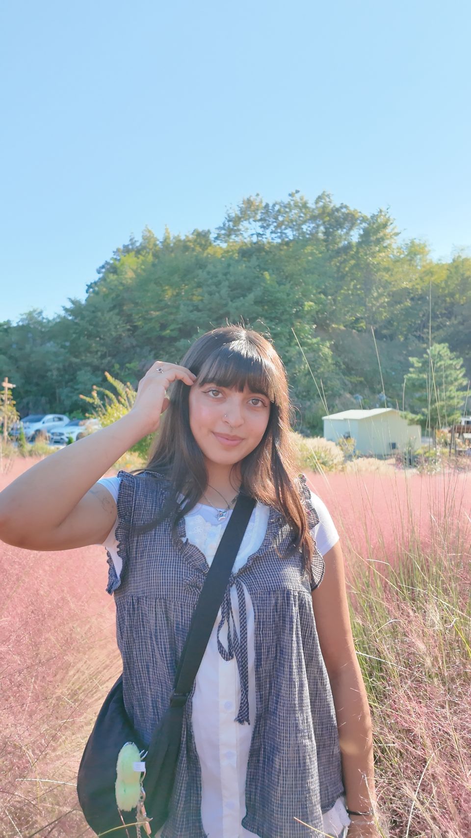 author posing in pink flower field