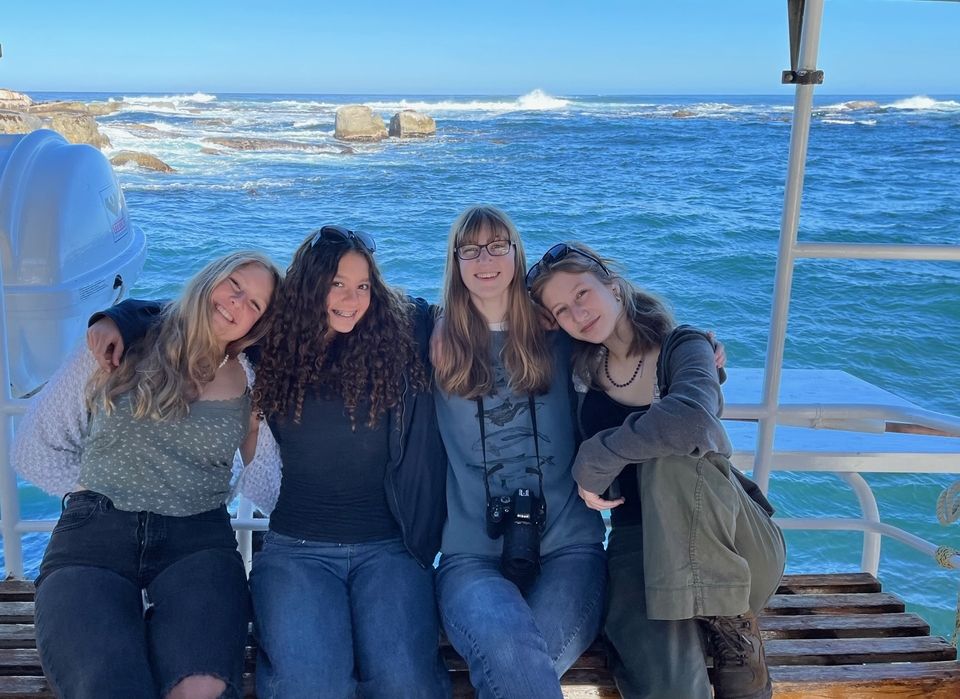 A group of students sitting on a boat