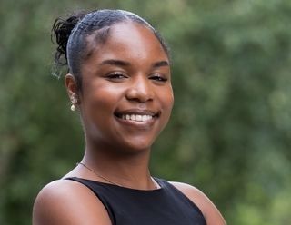 a headshot of Tianni wearing black with her hair pulled back