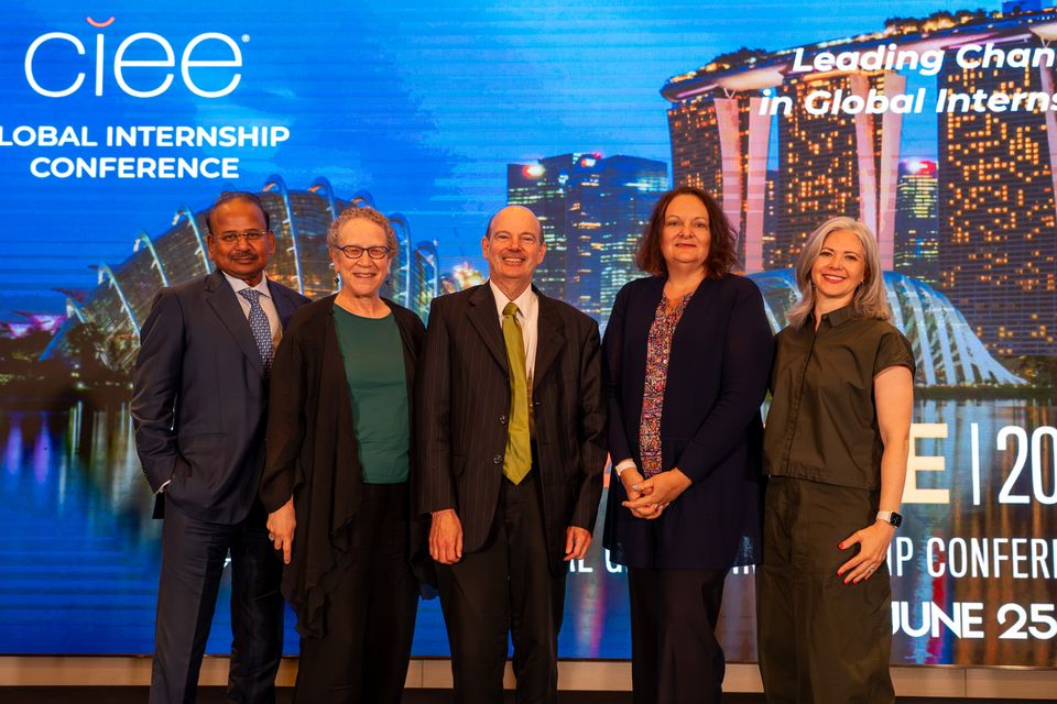 a group of 5 people standing on stage